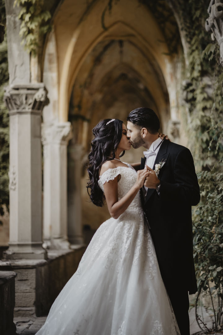 Bridal couple under the gothic colonnade