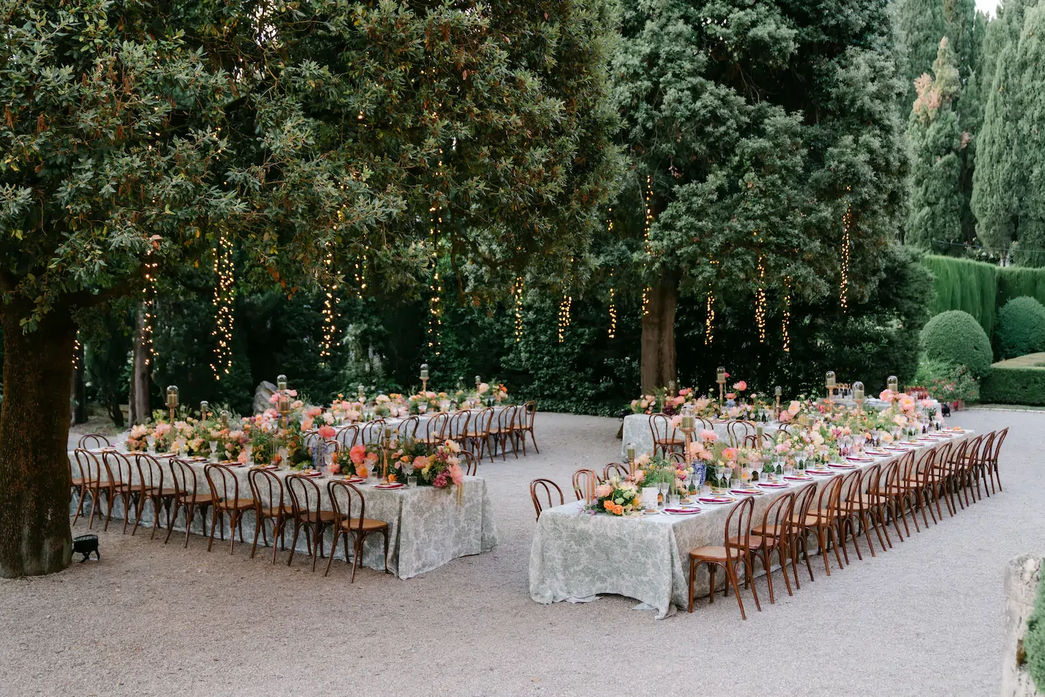 Outdoor Wedding Reception Table Setup Under Fairy Lights