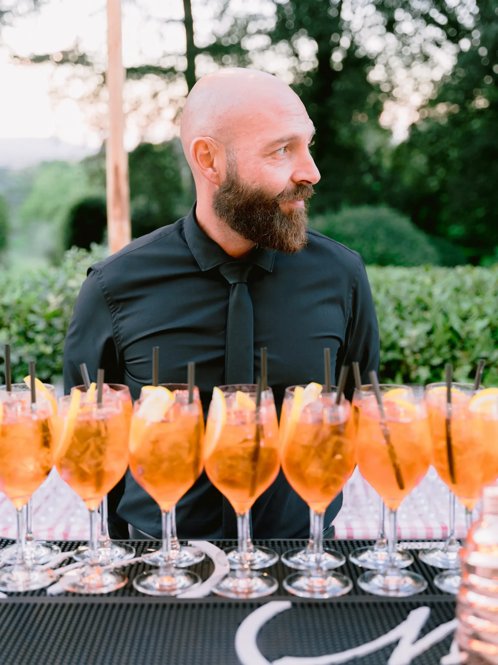 bartender preparing spritz for welcome dinner at Tenuta Bichi Borghesi