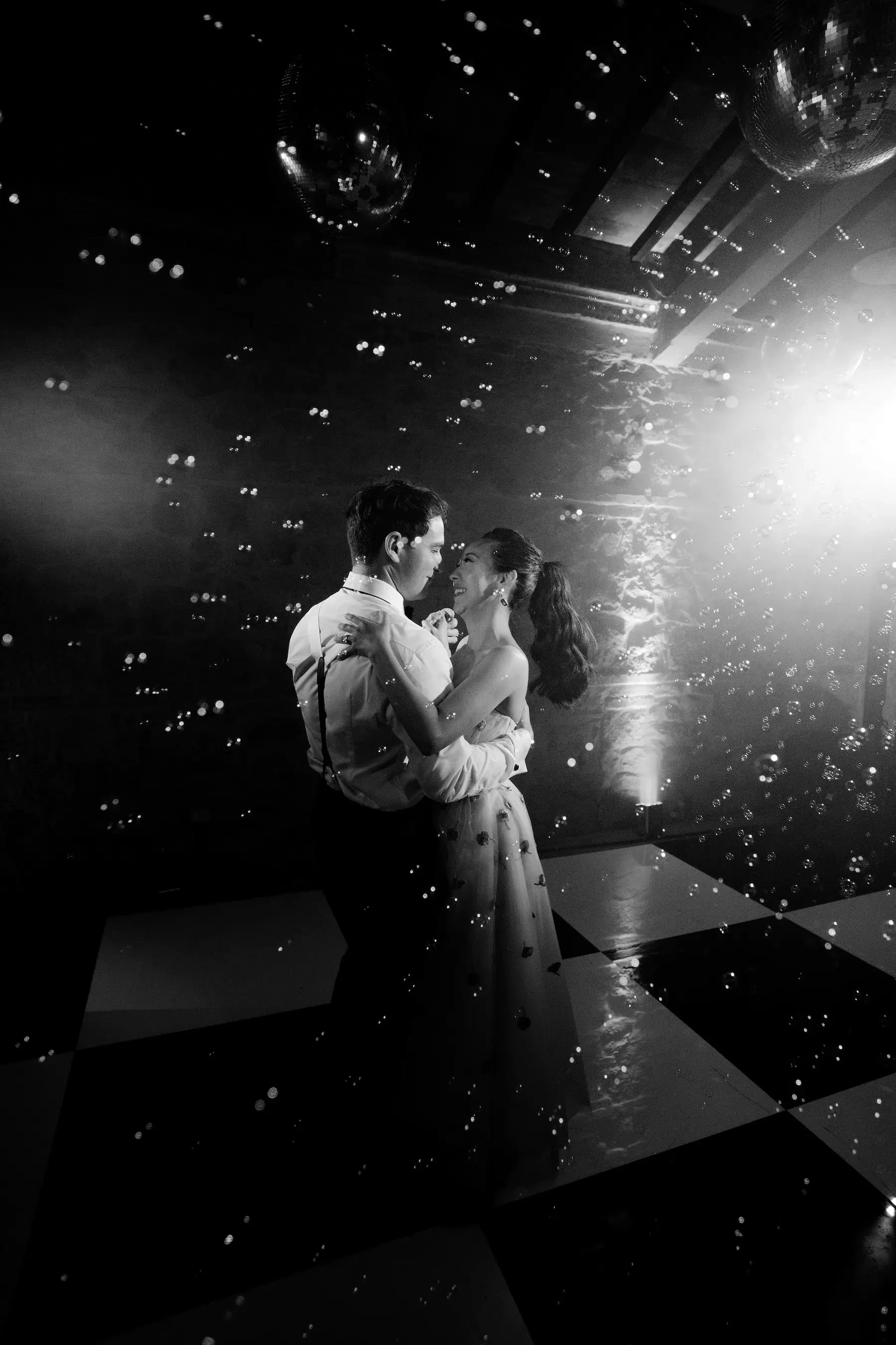 Black And White Bride And Groom Dance With Bubbles