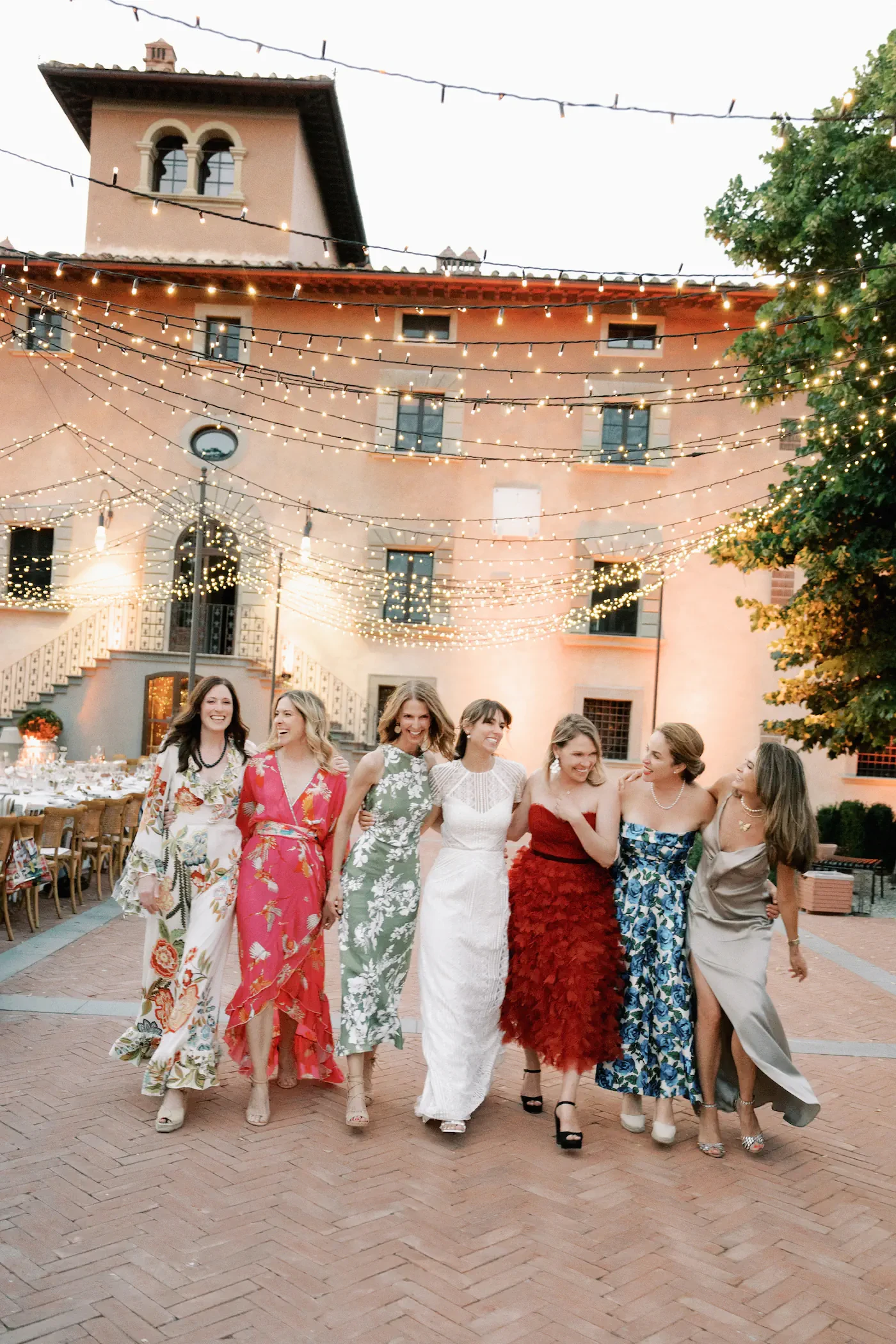 Bride and Bridesmaids Walking Courtyard Fairy Lights Vignamaggio