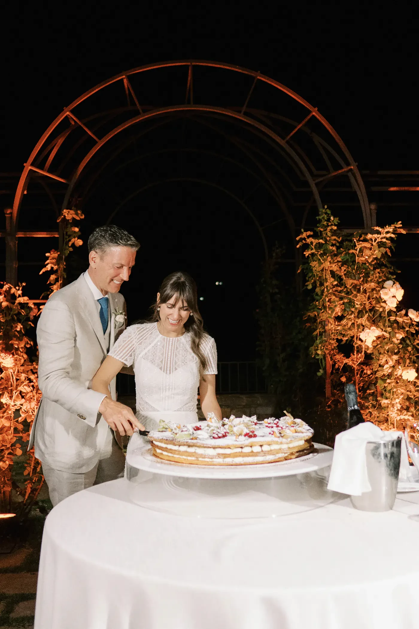 Bride and Groom Cutting Italian Wedding Cake Night