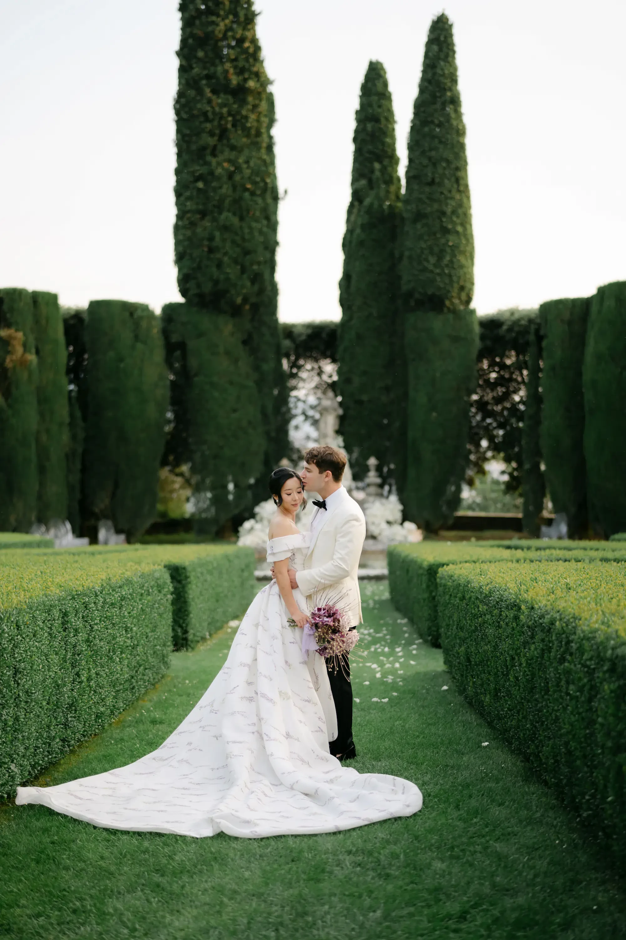 Groom Kissing Bride Forehead Garden Wedding Portrait