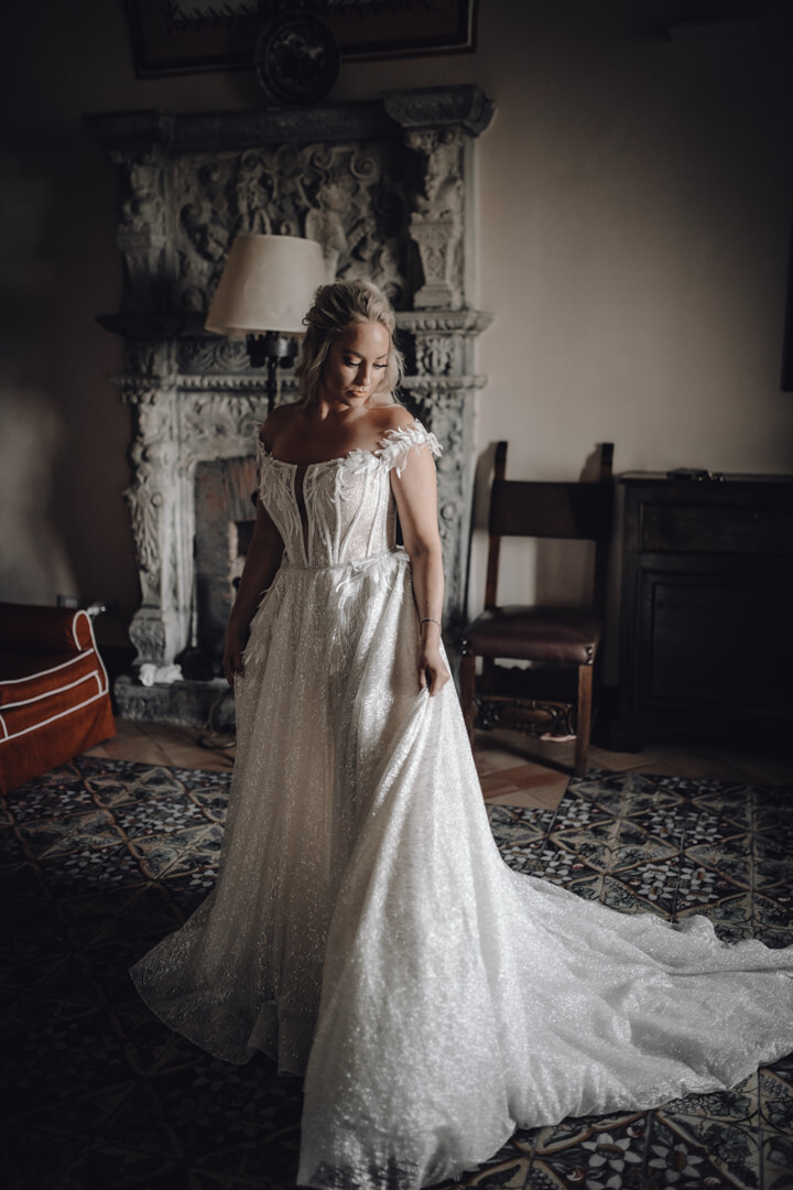 Portrait of the bride by an ancient fireplace