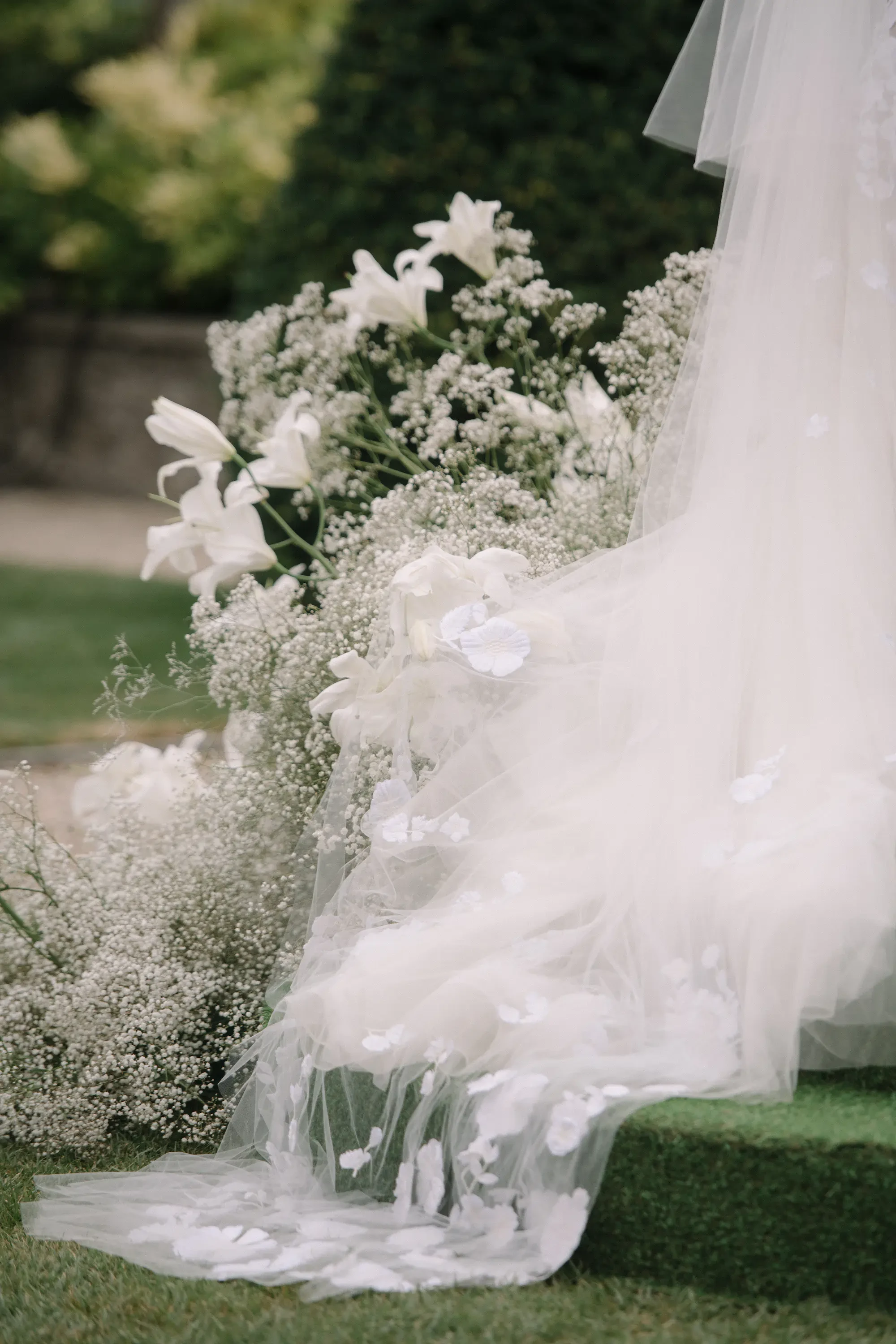 Detail of the Bride's dress and flowers during the wedding ceremony
