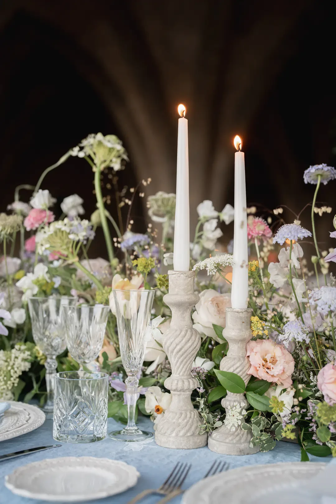 wedding place setting with candles and flowers