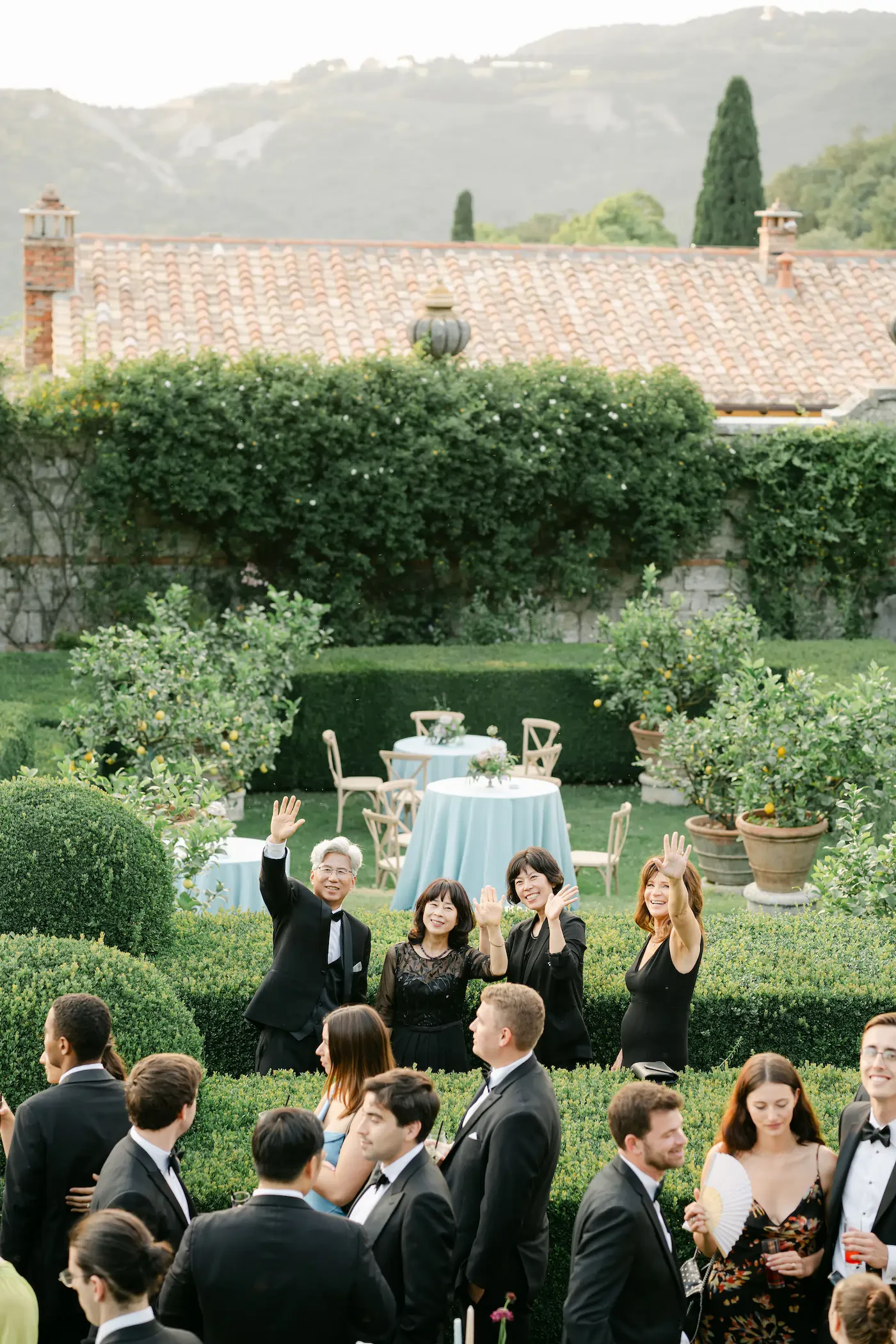 Wedding Guests Waving Cocktail Hour Garden