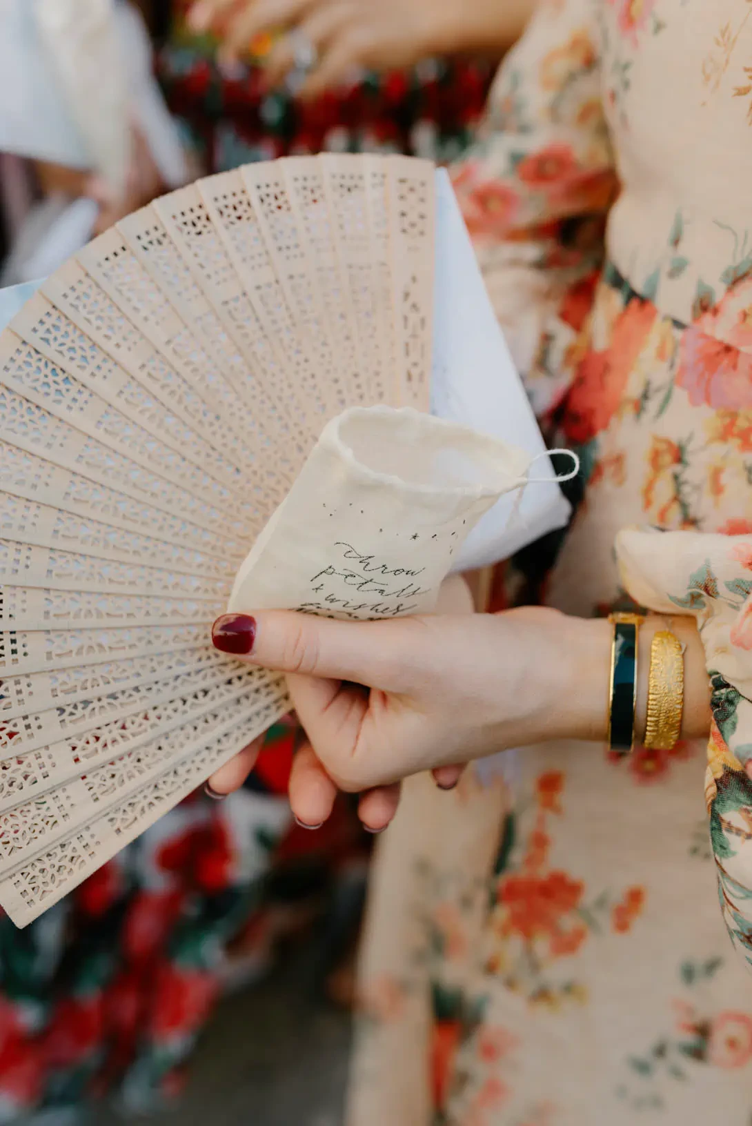 Bridesmaid holding a fan and petals