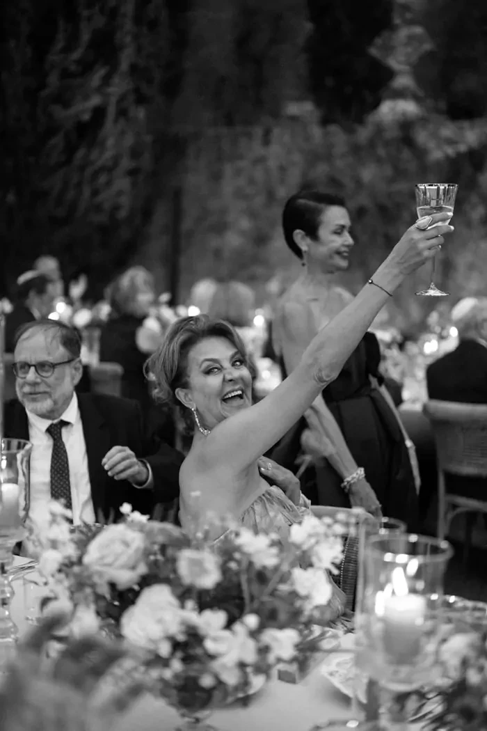 Black and white portrait of guests and family cheering at Davitta & Ryan's wedding