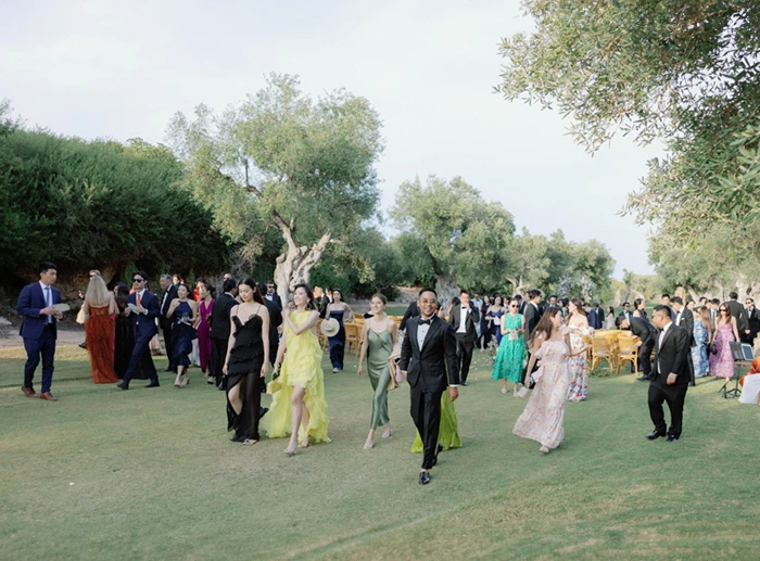 Wedding Guests Walking On Lawn After Outdoor Ceremony